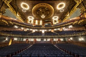 Emerson Colonial Theater's painted ceiling, chandeliers, and red velvet seats. 