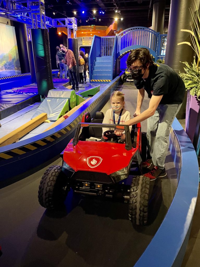 Little girl driving toy car