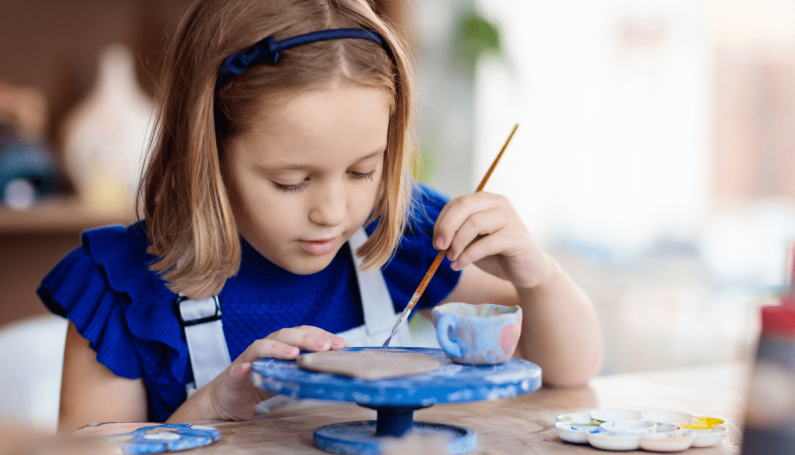child working on art project (Boston drop-in arts and crafts studios)