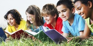 CHILDREN-READING books in the grass