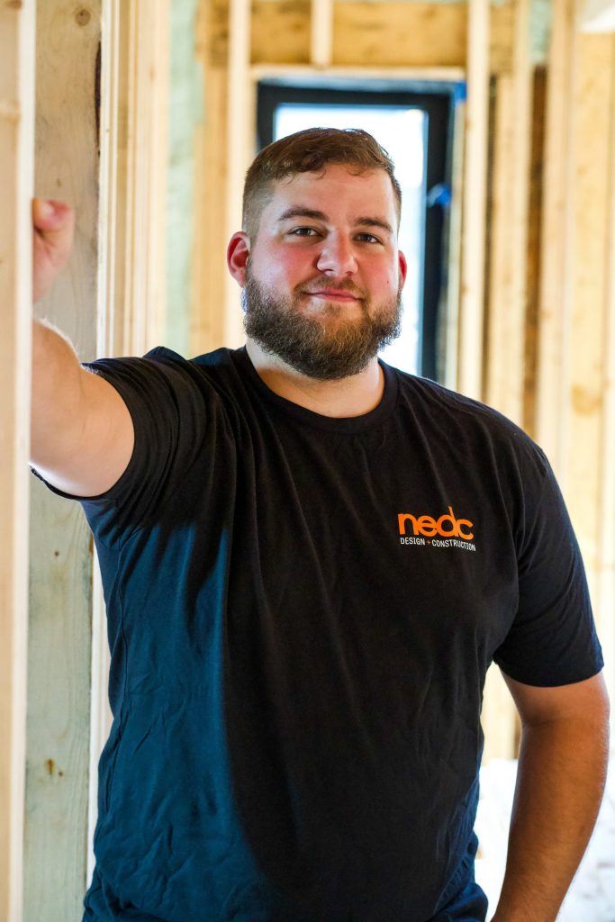 NEDC employee standing in unfinished house