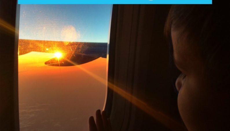boy looking out window at a plane: travel do's & don'ts with a toddler