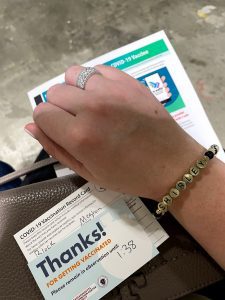 Woman's hand over vaccine card