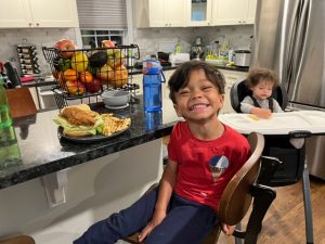 Children smiling with their dinner