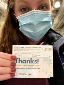 Woman holding vaccine card