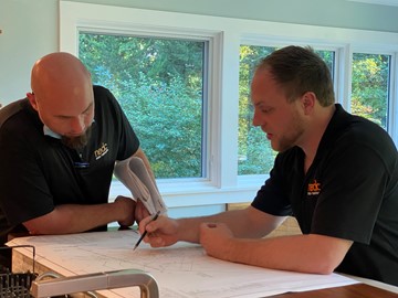 DesignBuild team meeting with project drawings