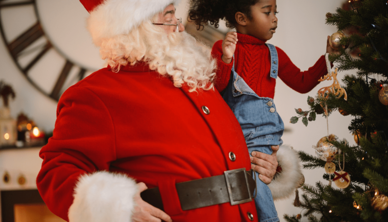 Santa holding little girl (where to find Santa in Boston)