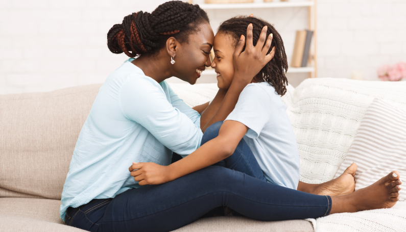 Black woman and child hugging (Black hair salons Boston)