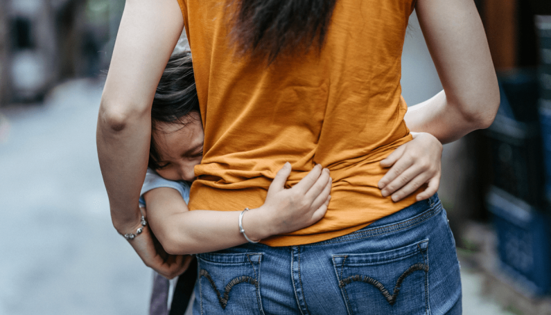 anxious child hugging anxious mother