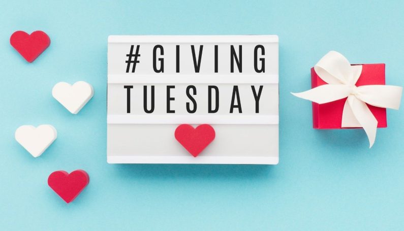 #GivingTuesday on a blue background with red and white hearts.