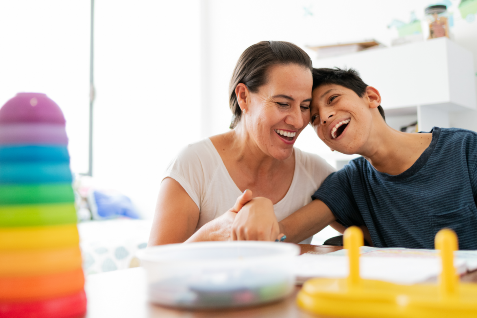 a mother plays with her son, who has cerebral palsy