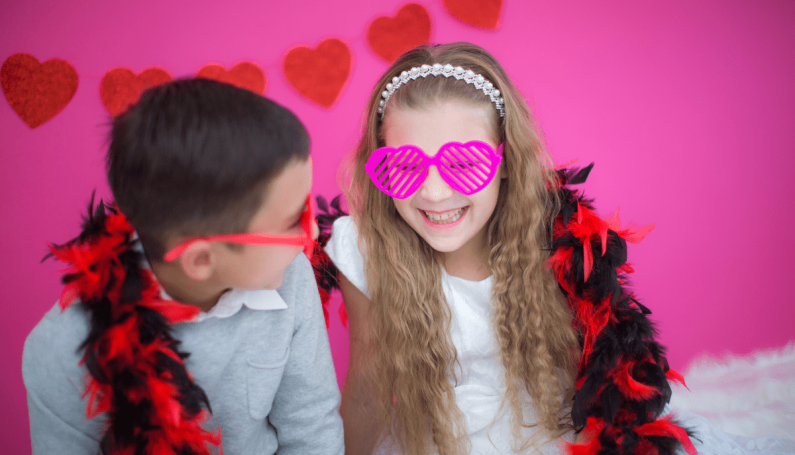 two children with Valentine's Day decor (Valentine's things to do in Boston with kids)