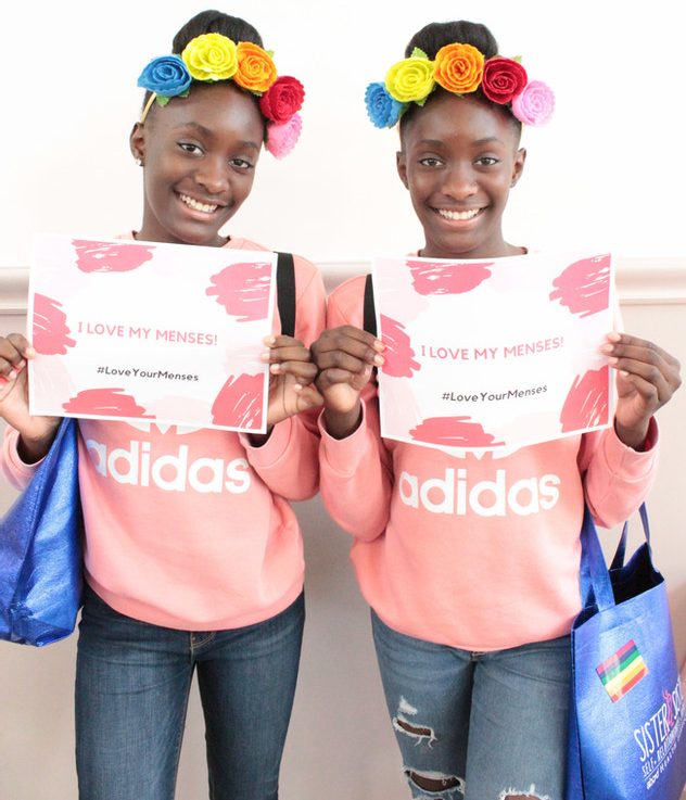 two girls holding certificates from love your menses