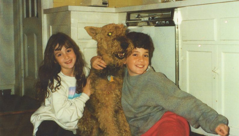 two children and their pet dog