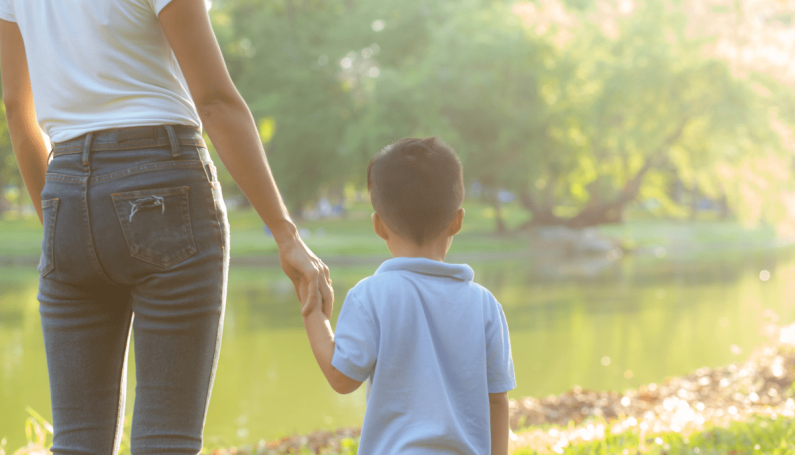 mother and son holding hands (autism diagnosis)