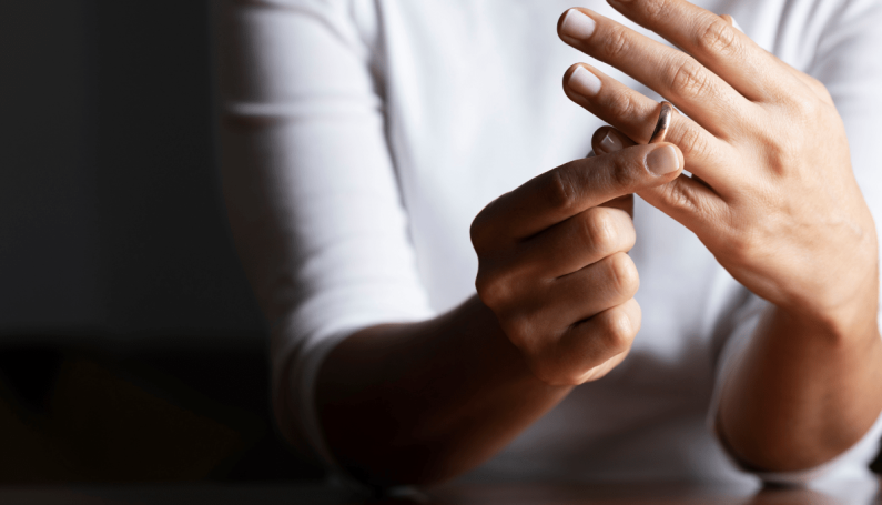 woman taking off wedding ring