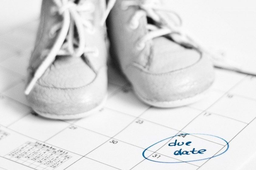 baby shoes on calendar with due date marked (lessons for my sister on becoming a new mom)