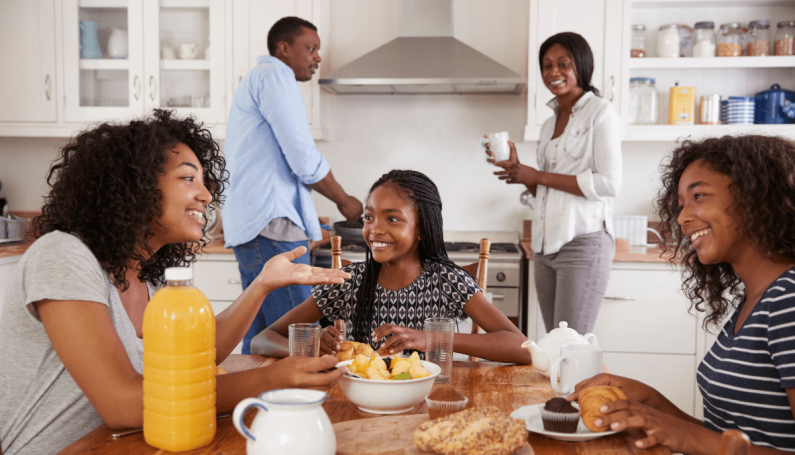 family in the kitchen having breakfast together (family bonding with older kids)