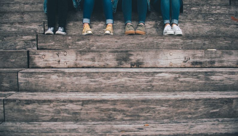 four pairs of high school students' legs and feet