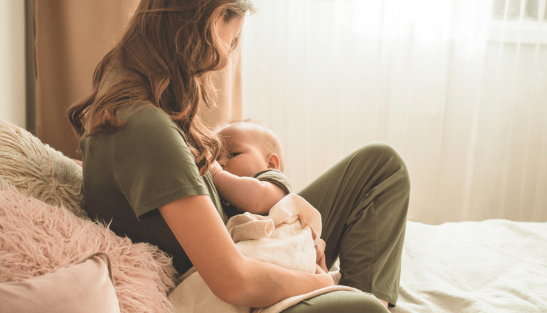woman holding baby to illustrate gender anxiety about a having a baby girl