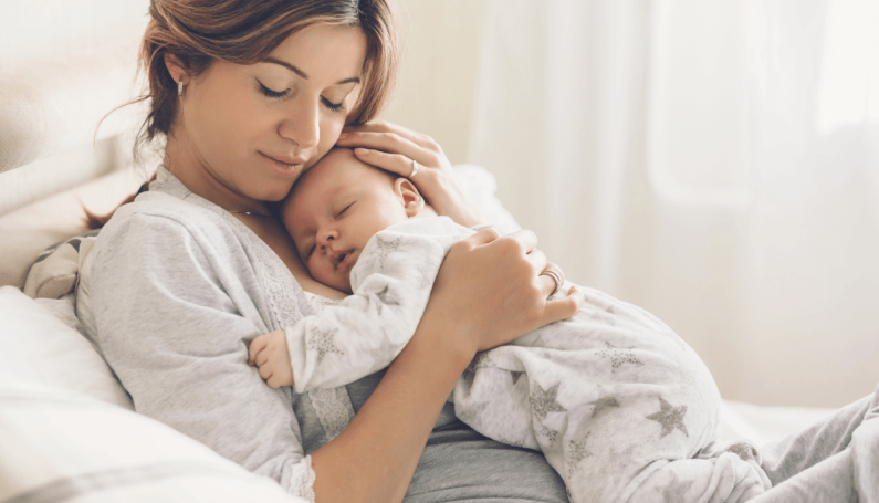 new mom holding baby (gift ideas for new mom)