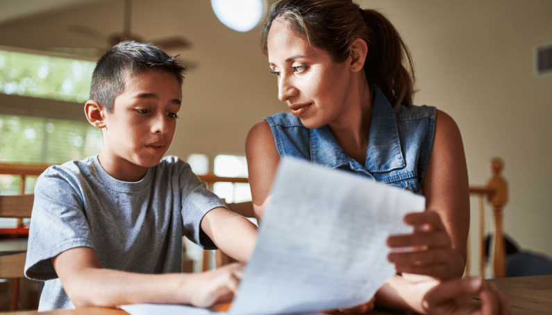 parent helping child with homework (child is not on the honor roll and I am proud, parent-teacher conferences)