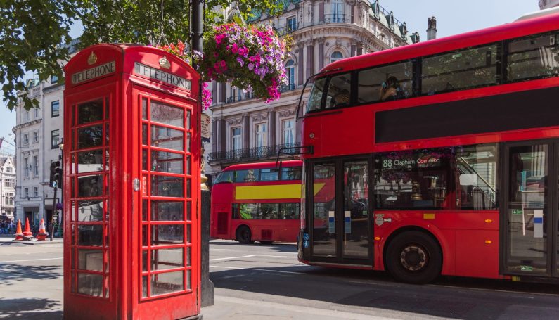 red phone booth with and red tour bus in london, england (my preschooler thinks he's british)