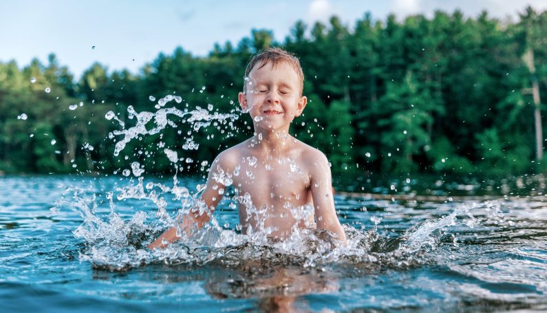boy splashing in a swimming pond or lake (swimming holes boston massachusetts)
