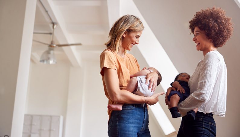 Two Mothers Meeting Holding Newborn Babies At Home (be the nicest mom in the room)