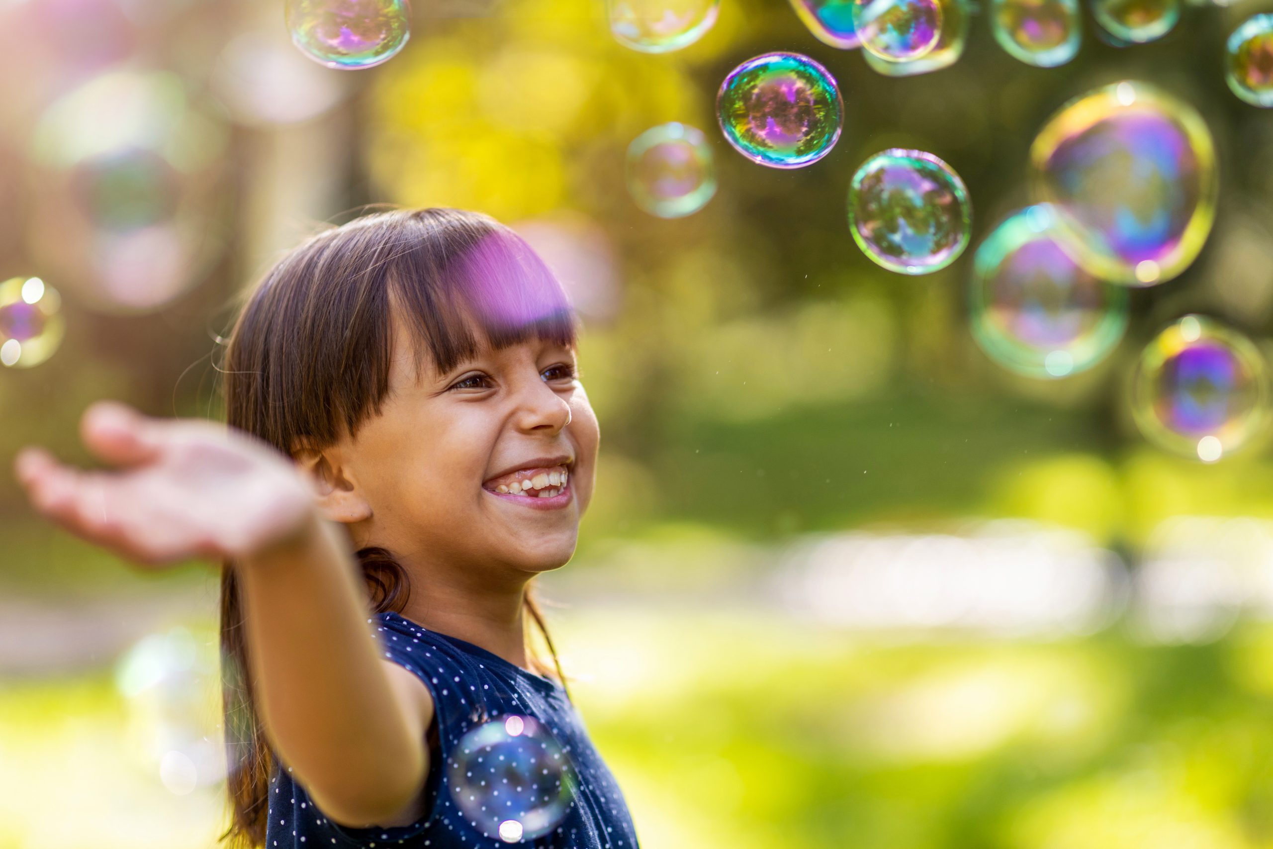 girl playing with bubbles outside (good kid, bad kid)