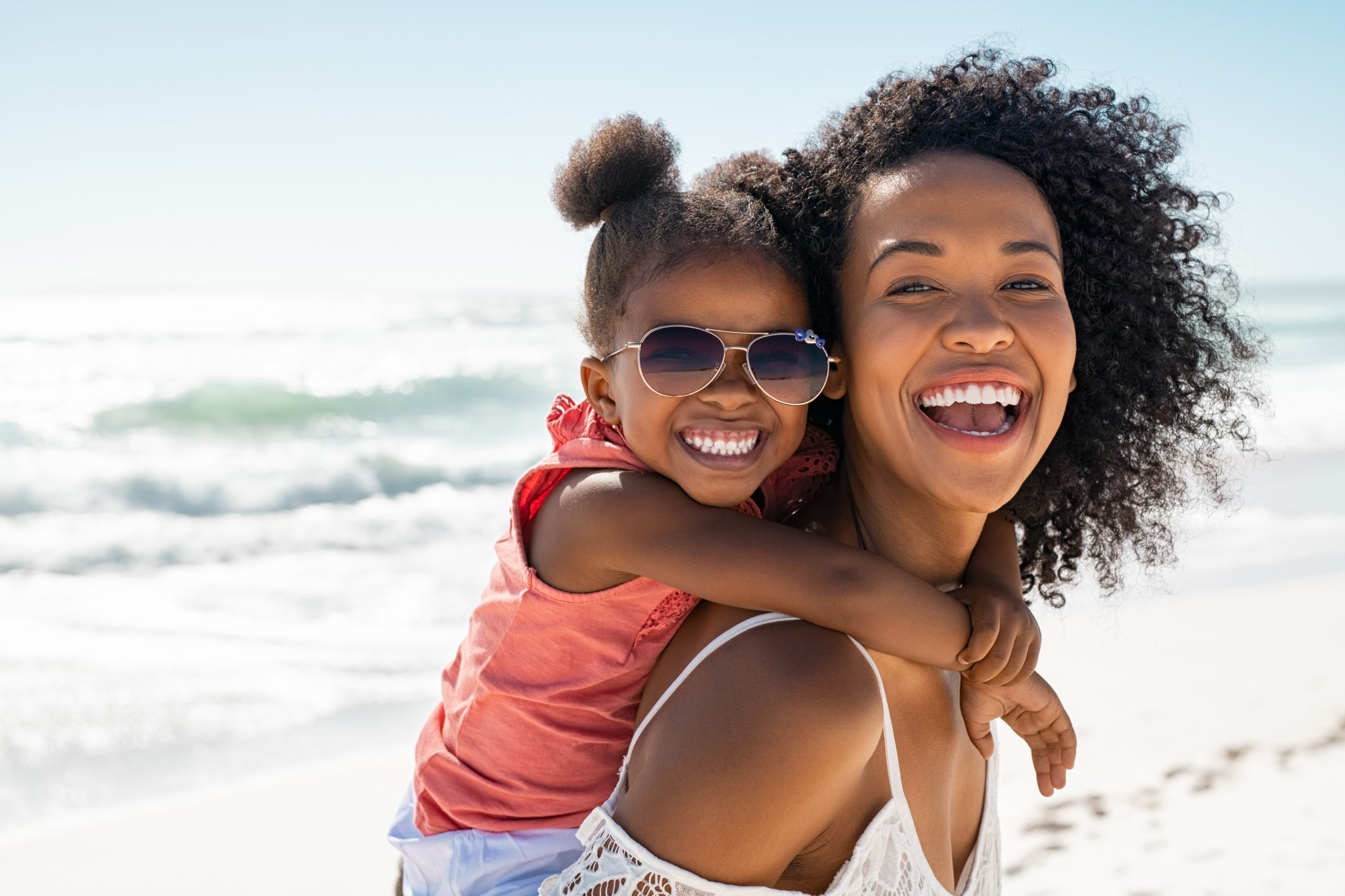 smiling mother and daughter at the beach (18 summers mom)