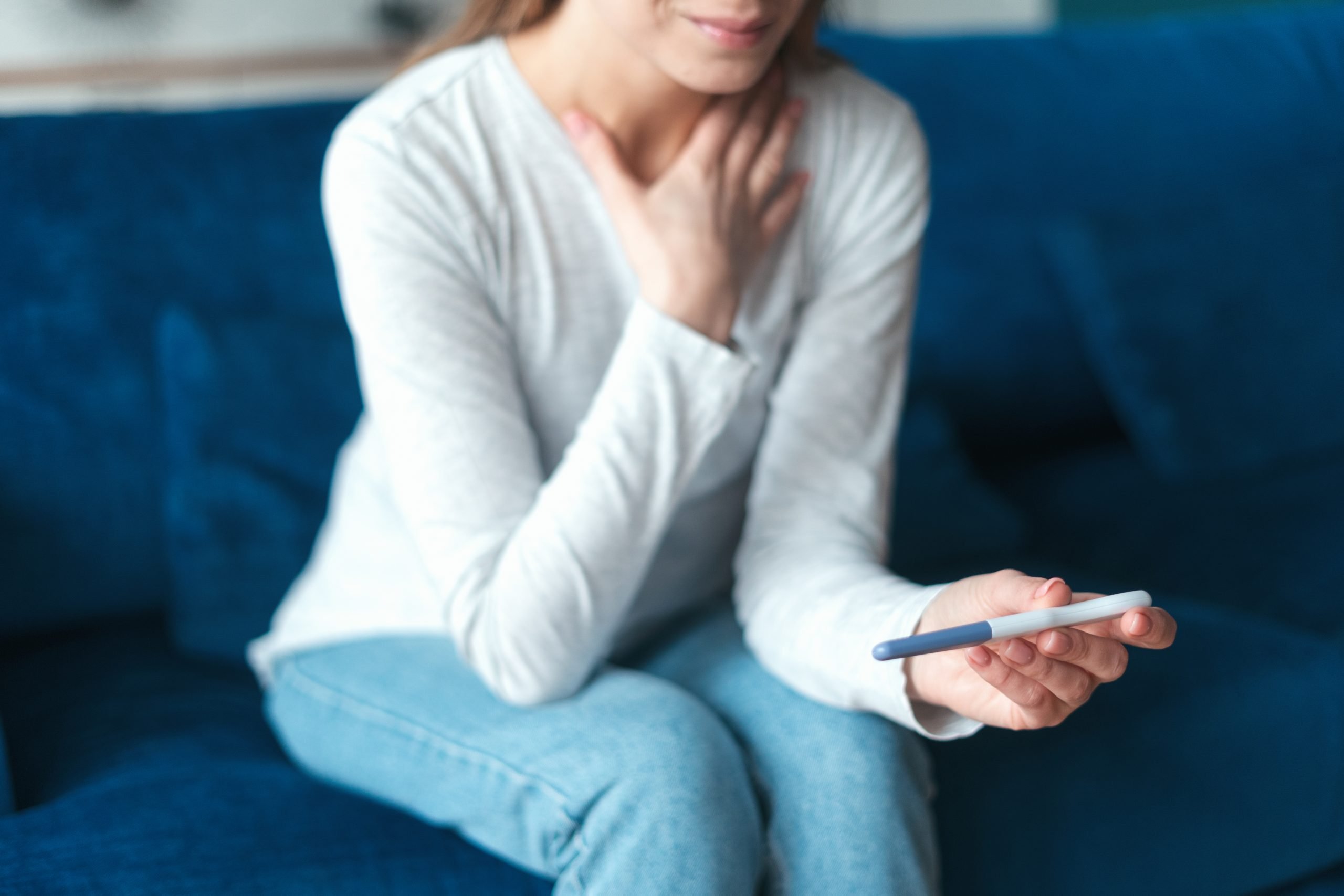 woman with pregnancy test (pregnancy loss, pregnancy after miscarriage)