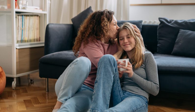 mother and daughter hugging at home (teenagers)