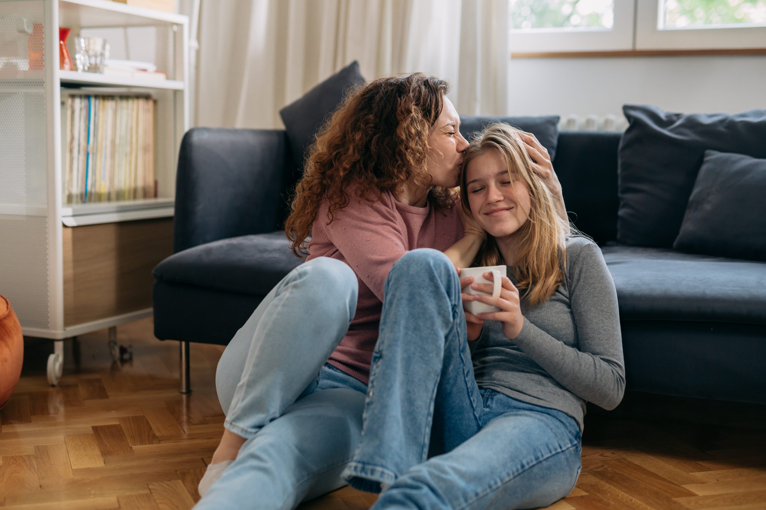 mother and daughter hugging at home (teenagers)
