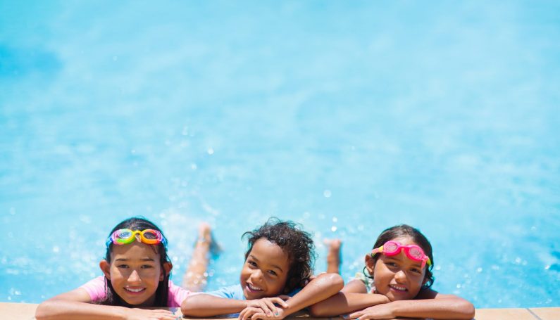Kids playing in outdoor swimming pool (Boston swimming pools)