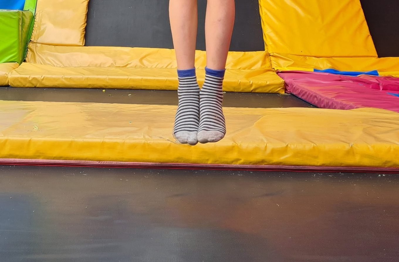 person jumping at a trampoline park (women and postpartum peeing or stress incontinence)