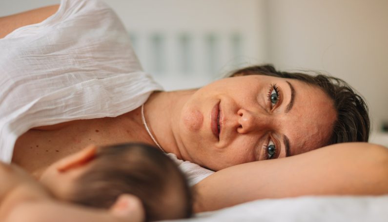 woman breastfeeding newborn baby (tongue tie and lip tie)