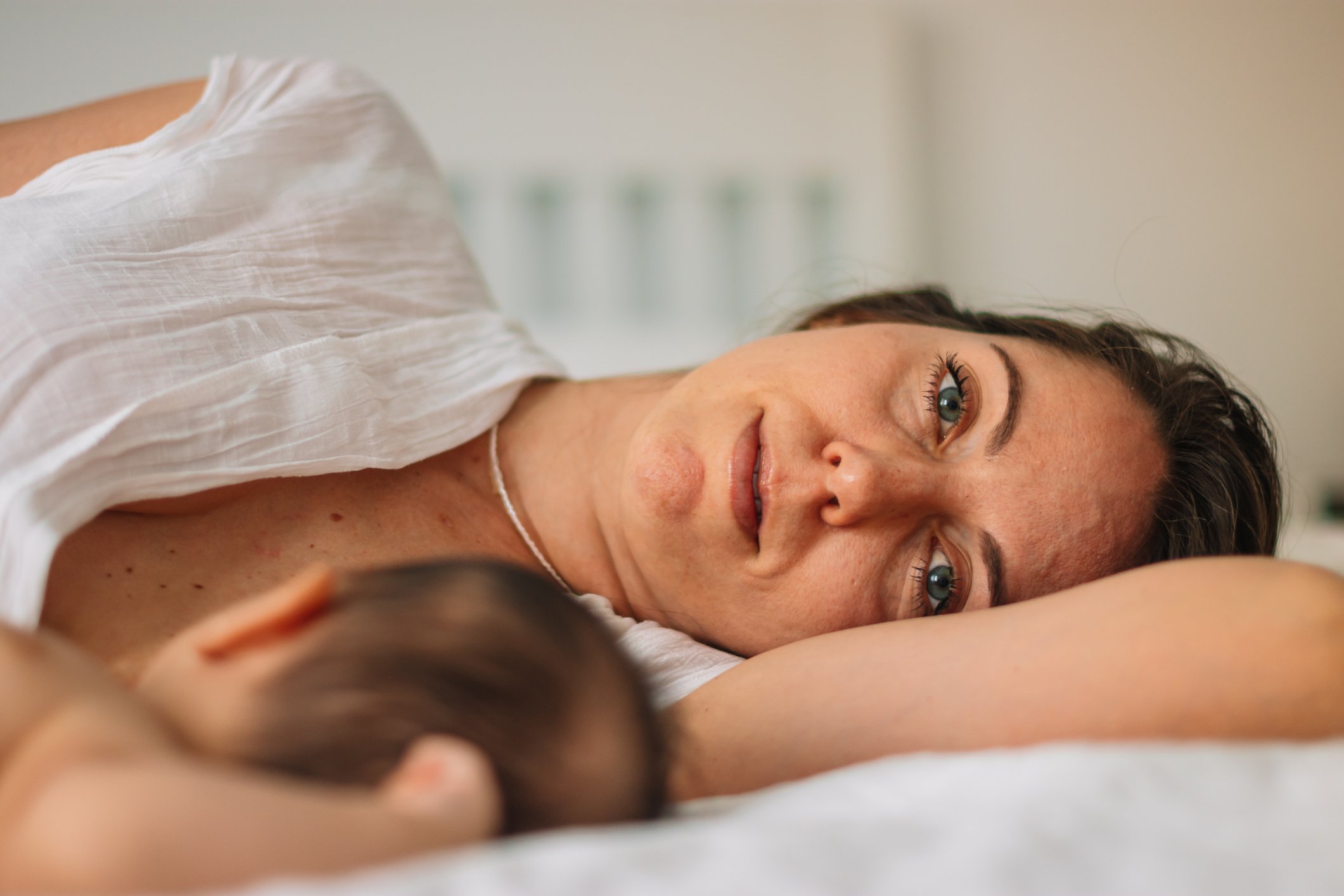woman breastfeeding newborn baby (tongue tie and lip tie)