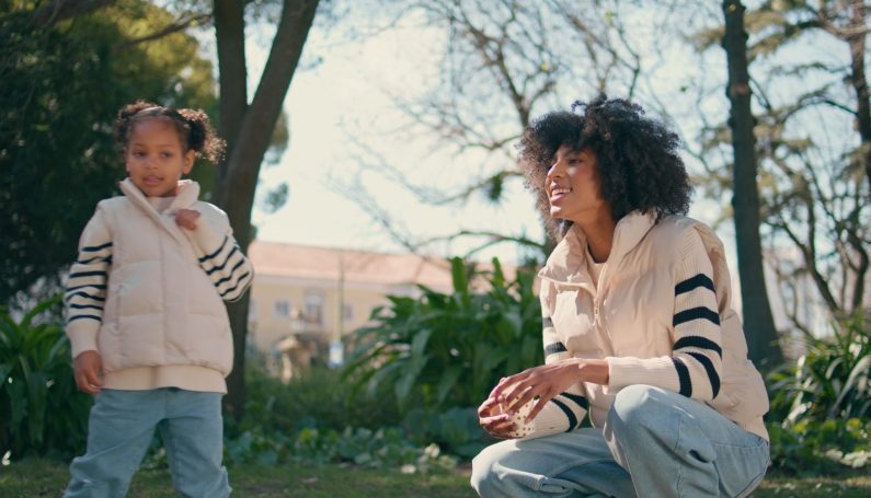 Mother daughter at park. (best jeans for moms 2024)