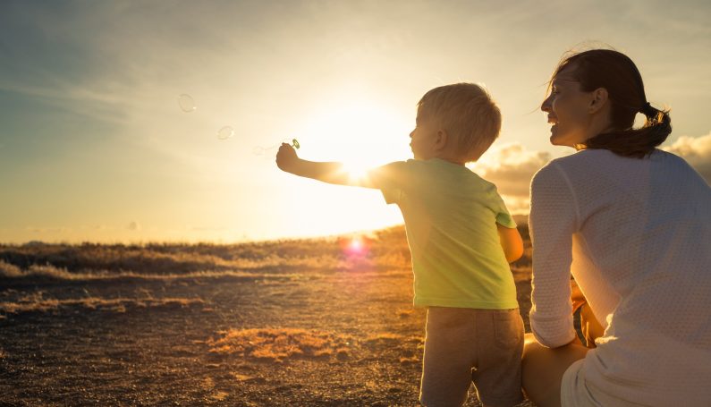 Mother and son watching beautiful sunset (how to respond to kids big life questions)