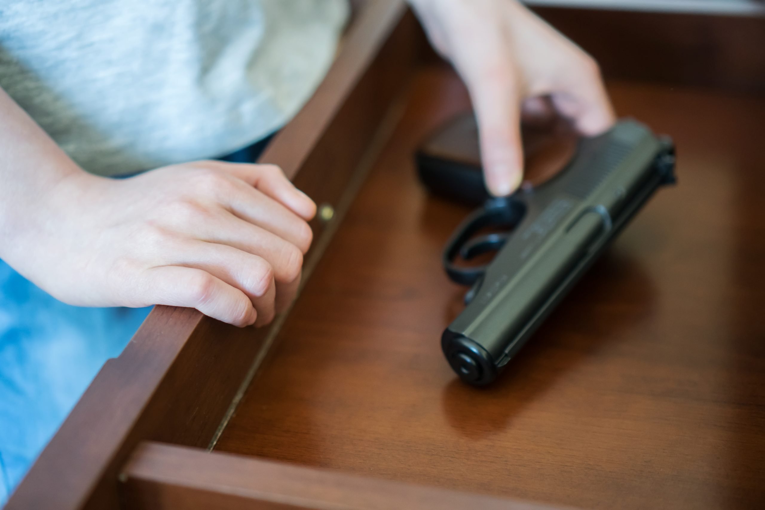 pistol in drawer at home (children and accidental gun death, parents keeping guns in the home during playdate)