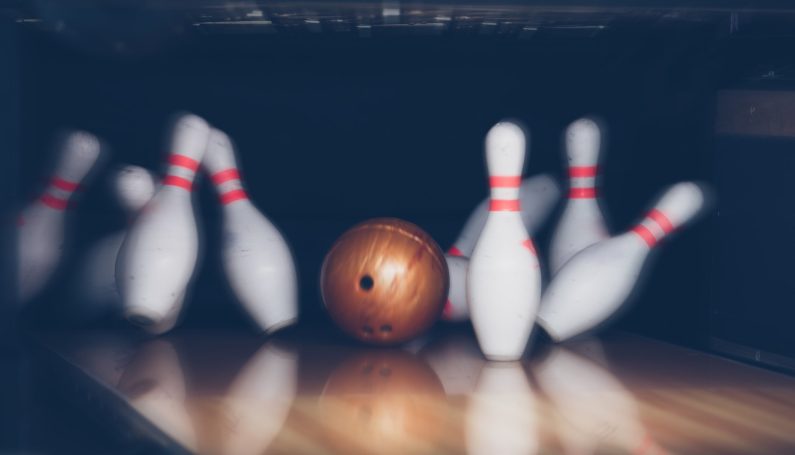 bowling ball knocking down bowling pins (best bowling alleys Boston)
