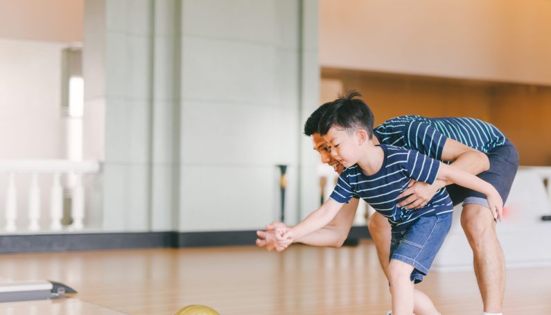 child and father bowling (free and cheap things to do in MetroWest Boston this summer)