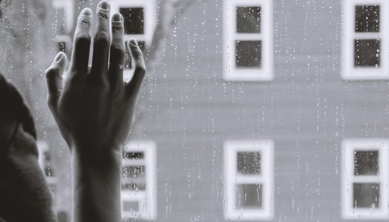 hand against a rain-covered window (When Your Friend Is Depressed for a Really, Really Long Time :: 6 Ways to Show You Care)