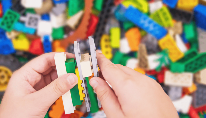 child playing with Legos
