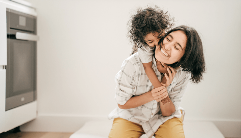 mom and child hugging in kitchen (minimalist mom, minimalism)