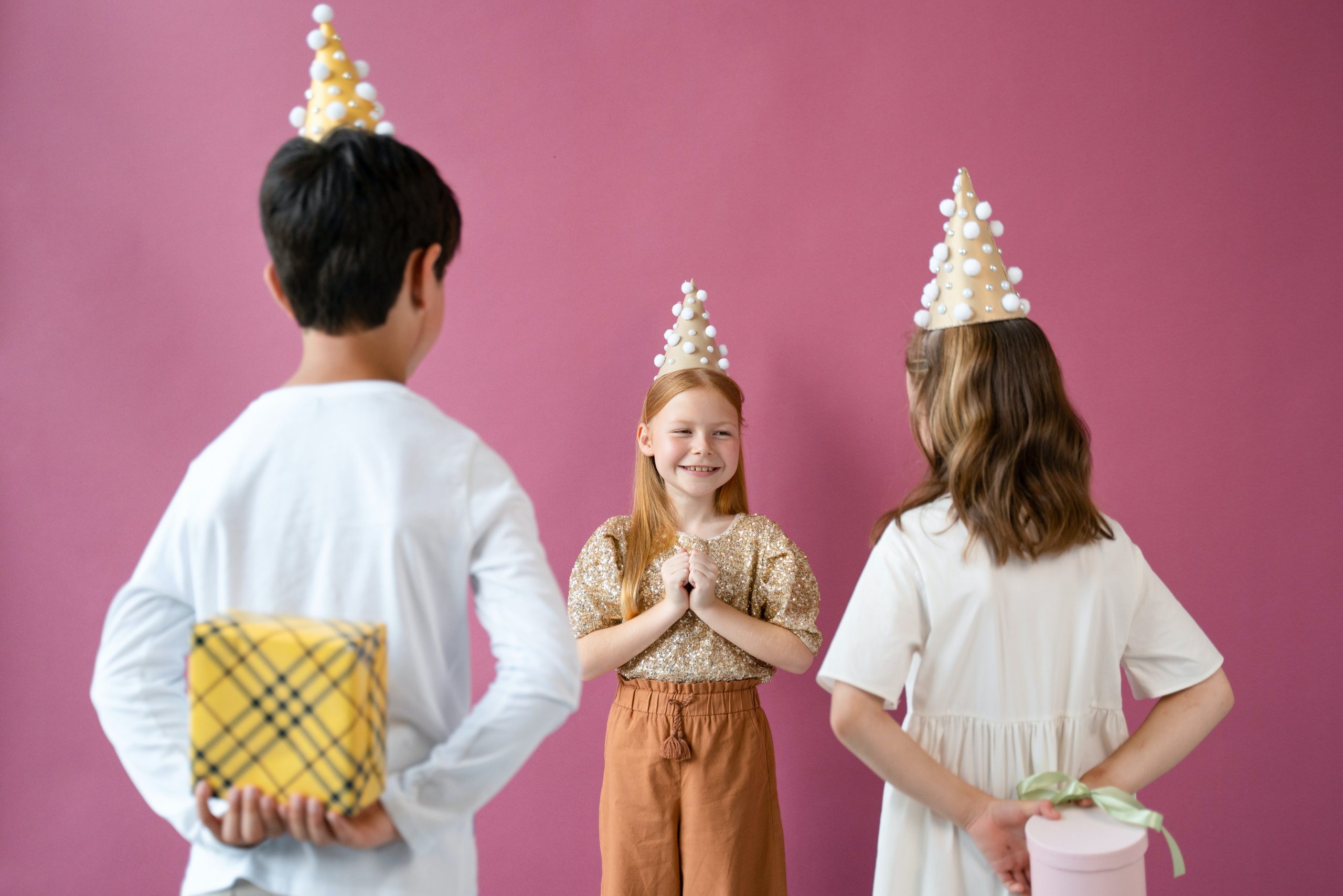 Girl with red hair in the center faces two children with gifts behind their backs