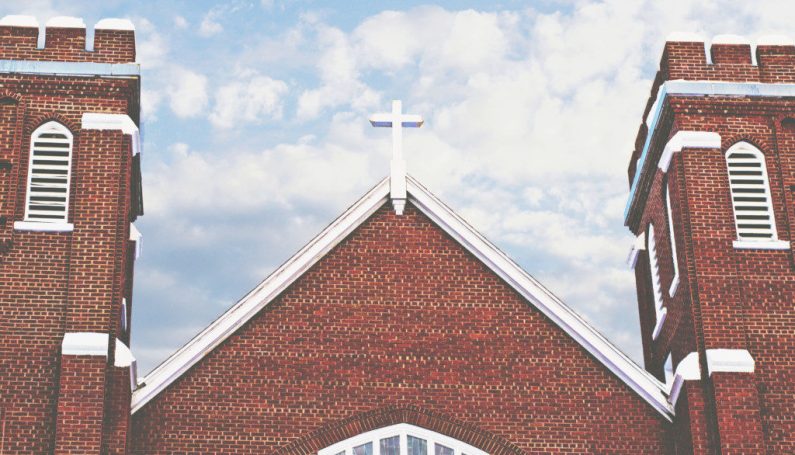 brick church with cross on top (teaching kids about religion)