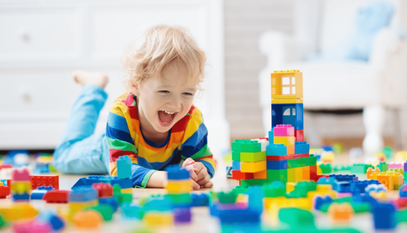 happy child playing with blocks (why i play with my children as little as possible)