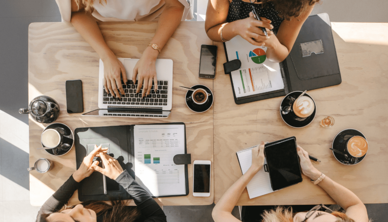 group of women working together in coffee shop (professional development for women and moms in Boston)